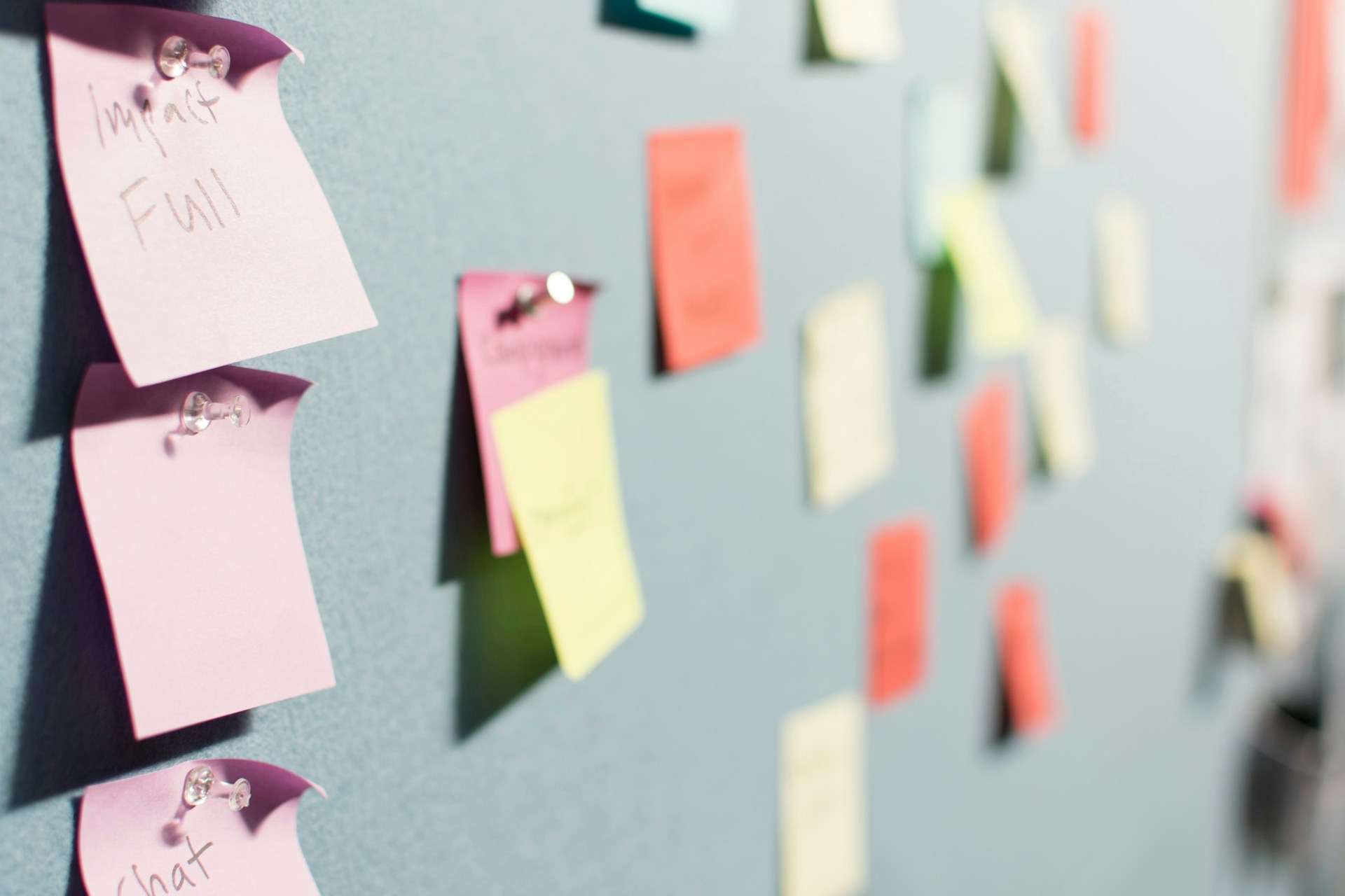 Colorful sticky notes covering a wall during a brainstorming session